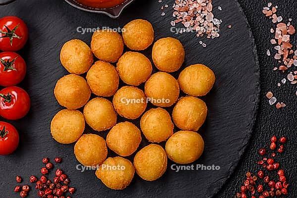 Food, Cheese or potato balls breaded with salt, spices and herbs. Fast food, junk food [IBR124773783]