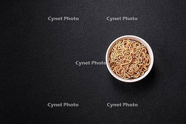 Food, Asian dish rice noodles with salt and spices on dark concrete background [IBR124773785]