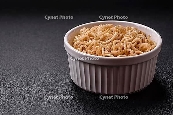 Food, Asian dish rice noodles with salt and spices on dark concrete background [IBR124773786]