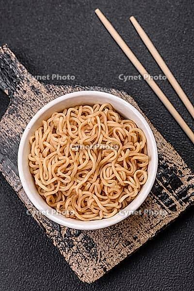 Food, Asian dish rice noodles with salt and spices on dark concrete background [IBR124773792]