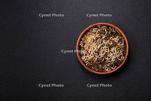 Food, Asian dish rice noodles with salt and spices on dark concrete background [IBR124773794]