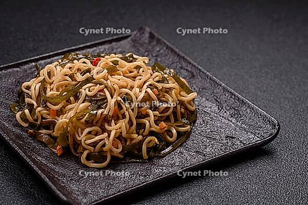 Food, Asian dish rice noodles with salt and spices on dark concrete background [IBR124773795]