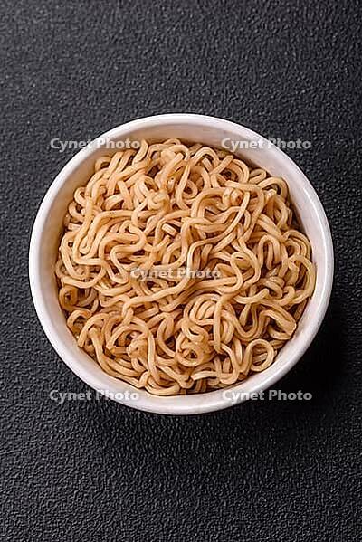 Food, Asian dish rice noodles with salt and spices on dark concrete background [IBR124773796]