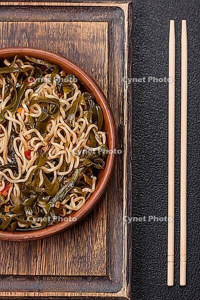 Food, Asian dish rice noodles with salt and spices on dark concrete background [IBR124773797]