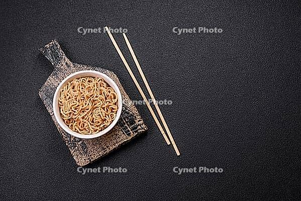 Food, Asian dish rice noodles with salt and spices on dark concrete background [IBR124773798]