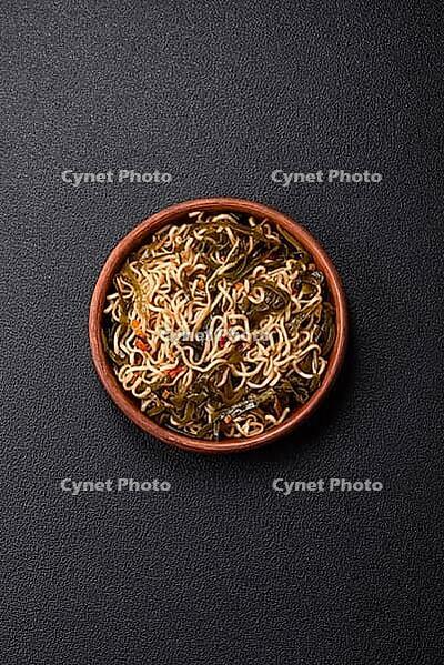 Food, Asian dish rice noodles with salt and spices on dark concrete background [IBR124773799]