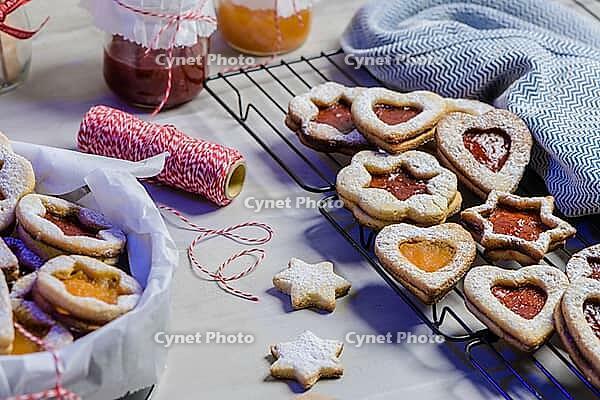 Homebaked Christmas Cookies With fruit Jam filling and Icing Sugar [IBR124817846]