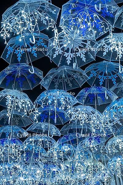The beauty of white umbrellas iluminated by Christmas lights decorating the streets of Agueda Portugal [IBR124817850]