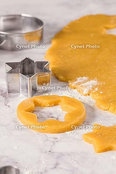 Raw dough for christmas cookies and cookie cutters on marble surface [IBR124817855]