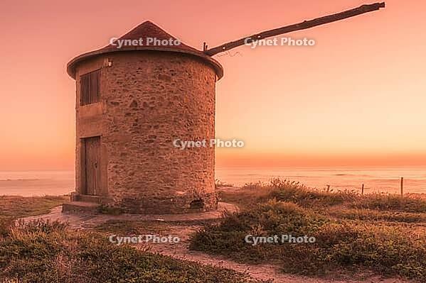 Old traditional wind-mill in sand-hills of Apulia Portugal [IBR124817867]