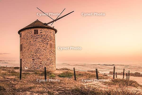 Old traditional wind-mill in sand-hills of Apulia Portugal [IBR124817868]