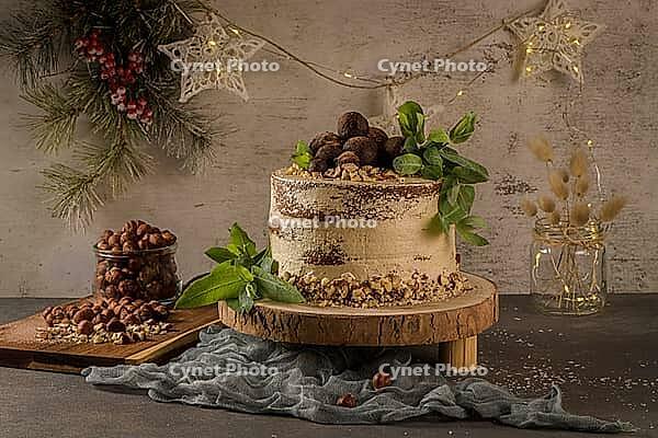 Delicious naked coffee and hazelnuts cake on table rustic wood kitchen countertop [IBR124817893]