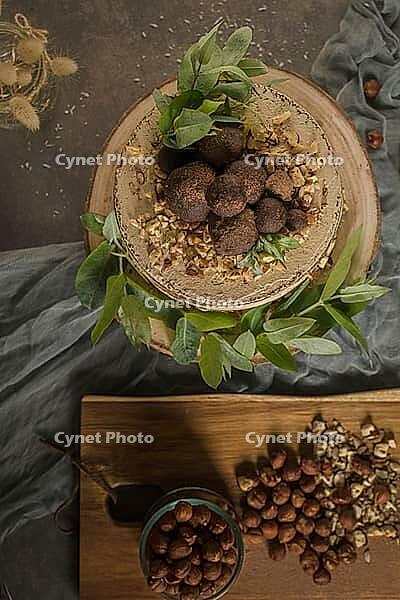 Delicious naked coffee and hazelnuts cake on table rustic wood kitchen countertop [IBR124817918]