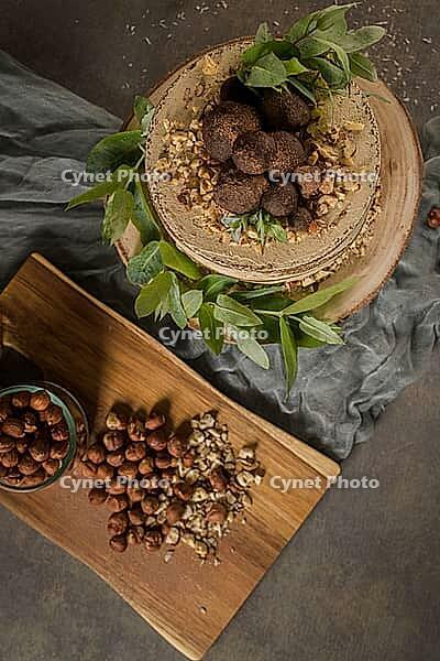Delicious naked coffee and hazelnuts cake on table rustic wood kitchen countertop [IBR124817919]