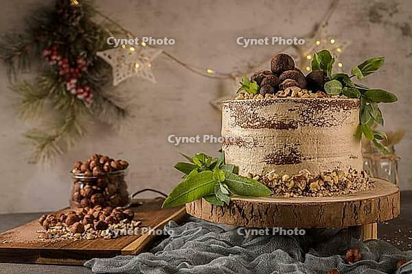 Delicious naked coffee and hazelnuts cake on table rustic wood kitchen countertop [IBR124817921]