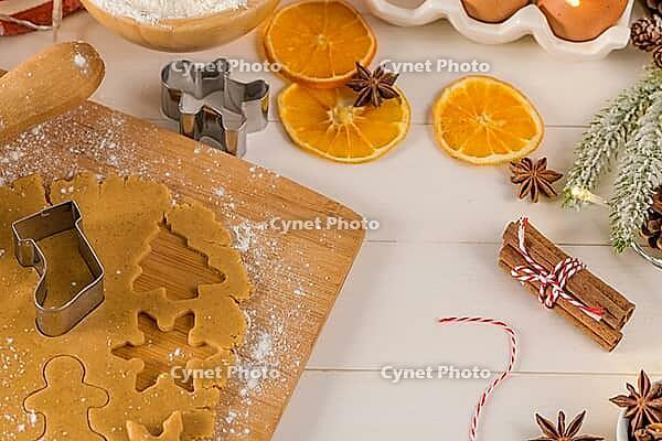 Raw dough for christmas cookies and cookie cutters on kitchen countertop [IBR124817924]