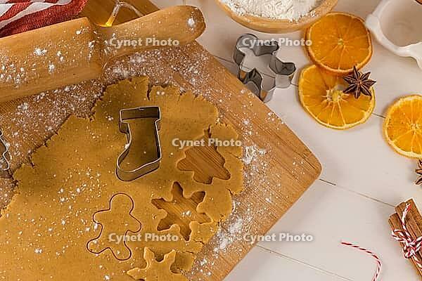 Raw dough for christmas cookies and cookie cutters on kitchen countertop [IBR124817926]