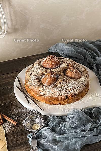 Delicious cake with pear, ginger and cinnamon on a dark kitchen counter [IBR124817928]