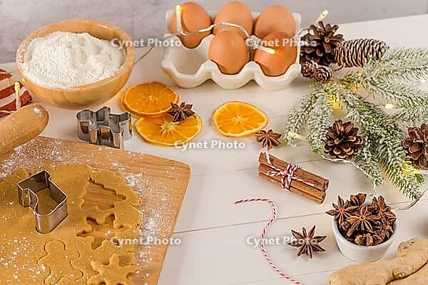 Raw dough for christmas cookies and cookie cutters on kitchen countertop [IBR124817931]