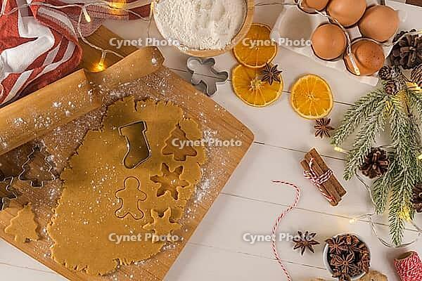 Raw dough for christmas cookies and cookie cutters on kitchen countertop [IBR124817933]