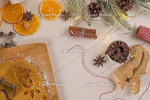 Raw dough for christmas cookies and cookie cutters on kitchen countertop [IBR124817936]