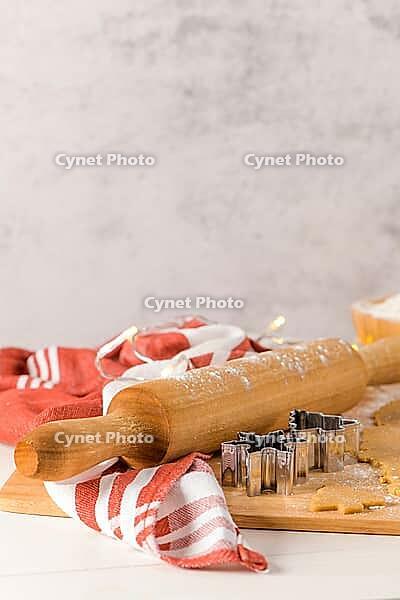 Raw dough for christmas cookies and cookie cutters on kitchen countertop [IBR124817937]
