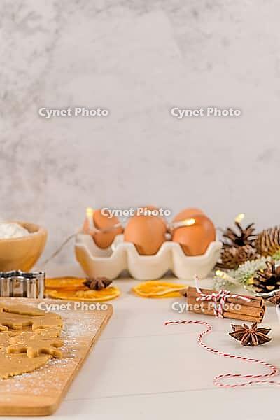 Raw dough for christmas cookies and cookie cutters on kitchen countertop [IBR124817938]