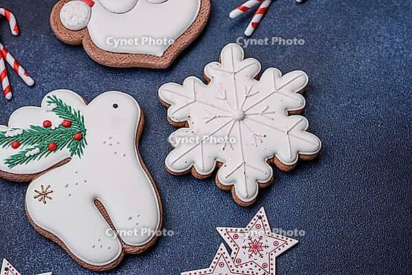 Food, Beautiful festive Christmas gingerbread made by hand with decoration elements on a dark concrete background [IBR124842034]