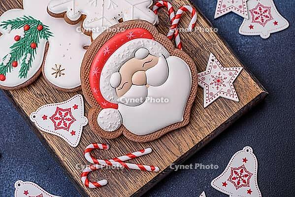 Food, Beautiful festive Christmas gingerbread made by hand with decoration elements on a dark concrete background [IBR124842042]
