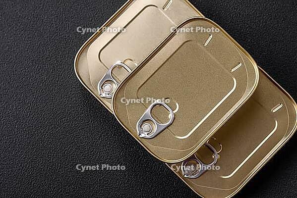 Food, Tin or aluminum rectangular can of canned food with a key on a dark concrete background [IBR124842043]