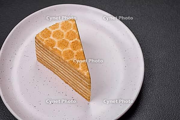 Food, Delicious fresh sweet honey cake layer cake with white cream on textured concrete background [IBR124842054]