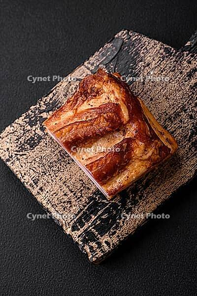 Food, Delicious calorie smoked bacon with salt, spices and herbs on a dark concrete background [IBR124842077]