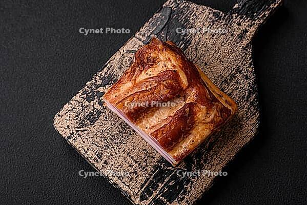 Food, Delicious calorie smoked bacon with salt, spices and herbs on a dark concrete background [IBR124842078]