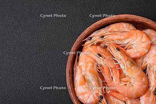 Food, Delicious fresh boiled tiger prawns with salt and spices on a ceramic plate on a dark concrete background [IBR124842091]