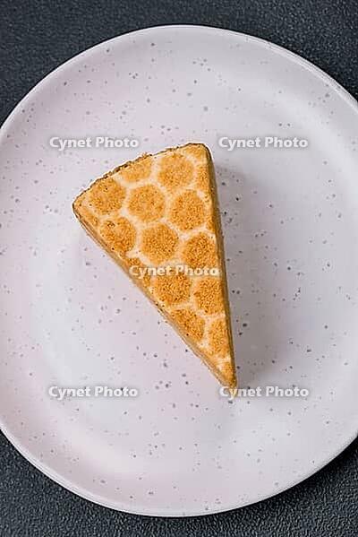 Food, Delicious fresh sweet honey cake layer cake with white cream on textured concrete background [IBR124842095]