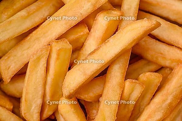 Food, Delicious crispy french fries with salt and spices in a cardboard box on a dark concrete background [IBR124842101]