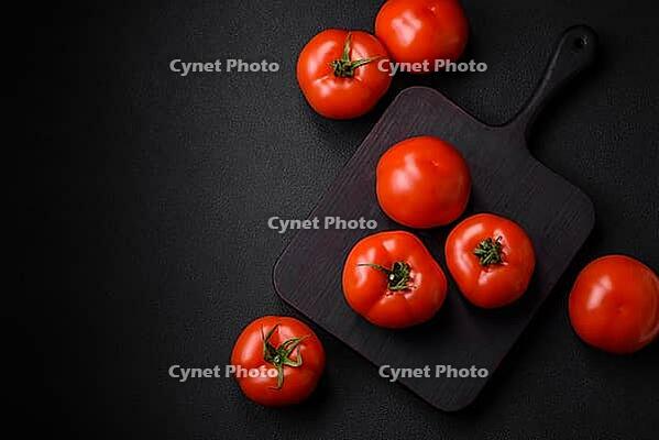 Food, Delicious fresh juicy tomatoes on a dark concrete background. Sauce Ingredients [IBR124842106]