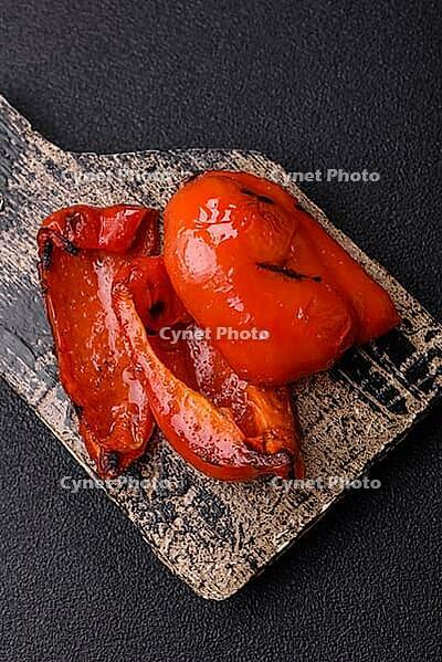 Grilled red bell peppers, vegetarian food. Red bell peppers as a food background for your design [IBR124865228]