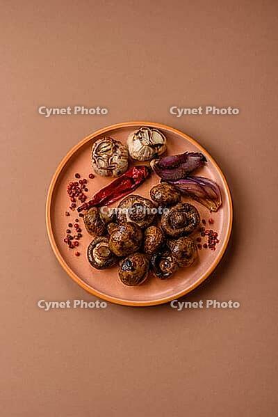 Grilled mushroom pieces, a vegetarian healthy meal with sauce. Barbecue mushroom halves as a food backdrop for your design [IBR124865234]