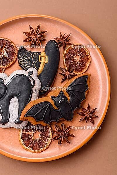 Halloween cookies, sweets, or gingerbread, a cat, a bat, and a hat. Halloween cookies as a backdrop for your design [IBR124865239]