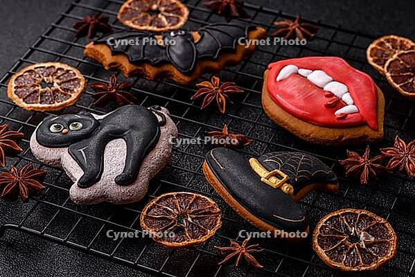 Halloween cookies, sweets, or gingerbread, a cat, a bat, and a hat. Halloween cookies as a backdrop for your design [IBR124865246]