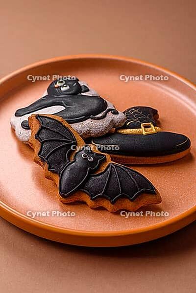 Halloween cookies, sweets, or gingerbread, a cat, a bat, and a hat. Halloween cookies as a backdrop for your design [IBR124865258]