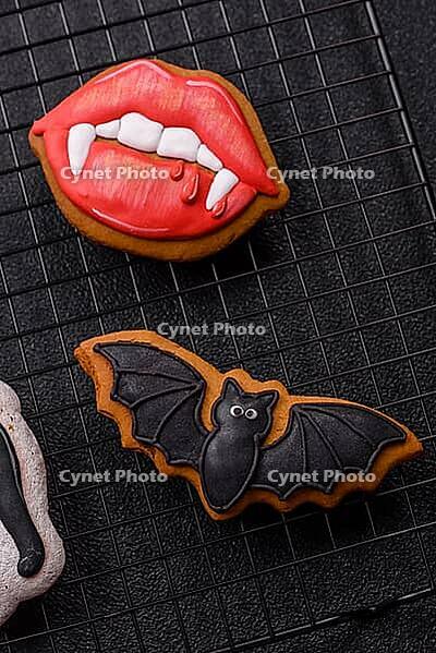 Halloween cookies, sweets, or gingerbread, a cat, a bat, and a hat. Halloween cookies as a backdrop for your design [IBR124865262]