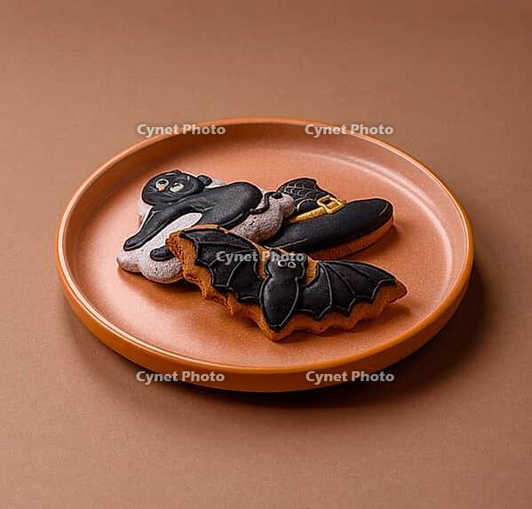 Halloween cookies, sweets, or gingerbread, a cat, a bat, and a hat. Halloween cookies as a backdrop for your design [IBR124865270]