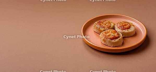 Round fish or chicken cutlets baked with tomato and cheese. Fish cutlets as a food backdrop for your design [IBR124865271]