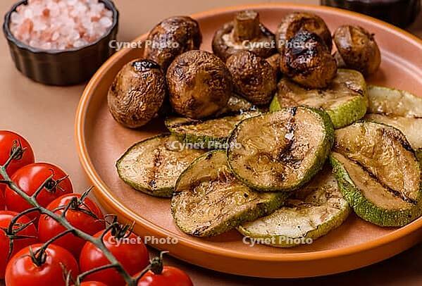 Grilled green zucchini slices, vegetarian food. Green barbecue zucchini as a food background for your design [IBR124865274]