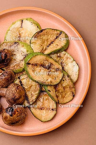 Grilled green zucchini slices, vegetarian food. Green barbecue zucchini as a food background for your design [IBR124865278]