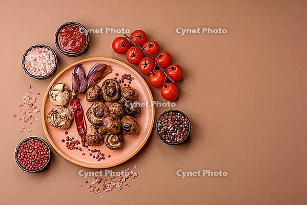 Grilled mushroom pieces, a vegetarian healthy meal with sauce. Barbecue mushroom halves as a food backdrop for your design [IBR124865280]
