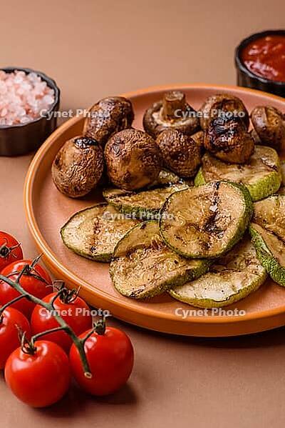 Grilled green zucchini slices, vegetarian food. Green barbecue zucchini as a food background for your design [IBR124865281]
