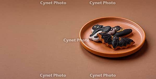 Halloween cookies, sweets, or gingerbread, a cat, a bat, and a hat. Halloween cookies as a backdrop for your design [IBR124865284]